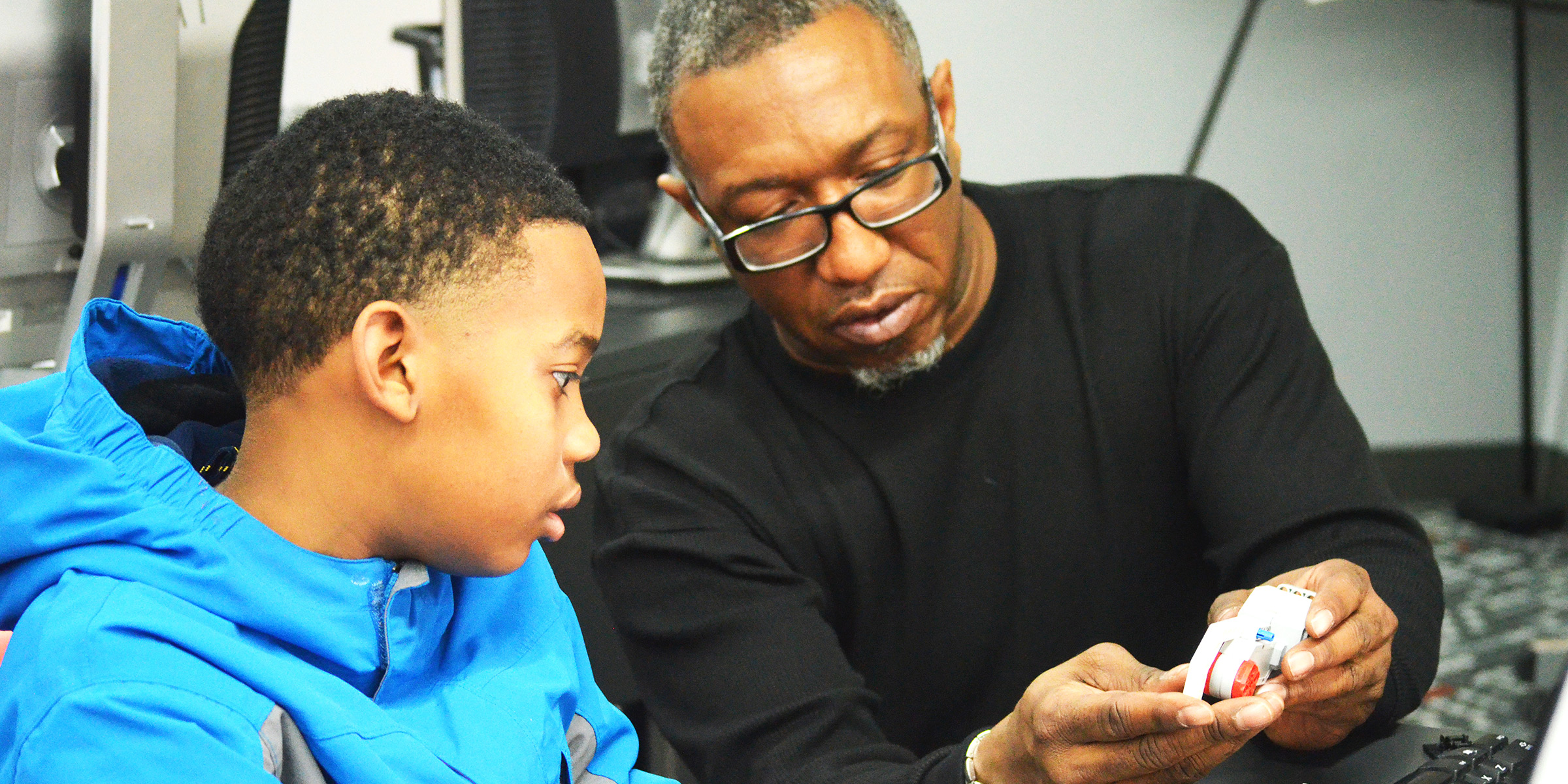 an older man mentoring a young boy