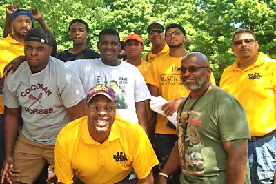 adult mentors and students outdoors