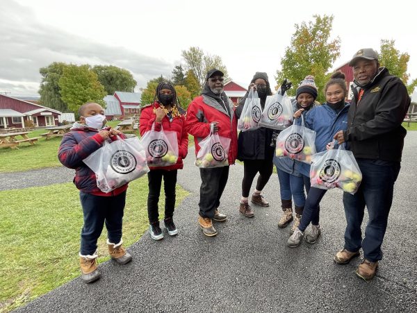 students and mentors apple picking outdoors