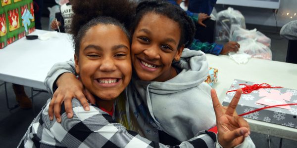 two young girls hugging and smiling